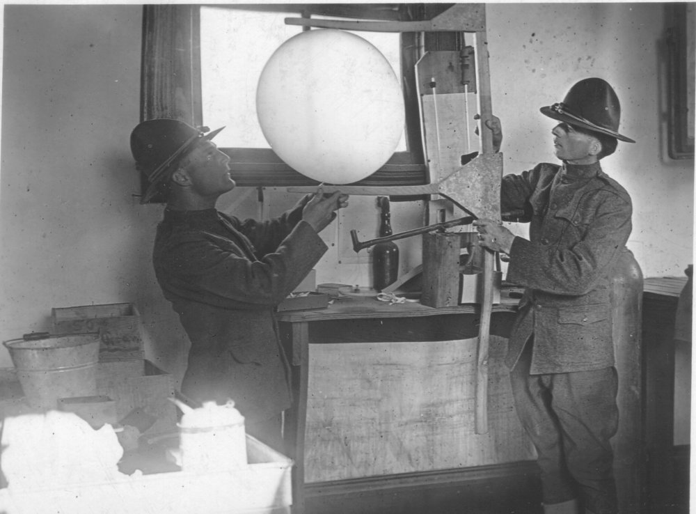 Privates Bly and Greening measure a weather balloon to ensure it is properly filled with hydrogen. Photo by A.W. Atkinson,&nbsp;US Army Signal Corps.&nbsp;Courtesy of the US Army Heritage and Education Center, Carlisle, PA.